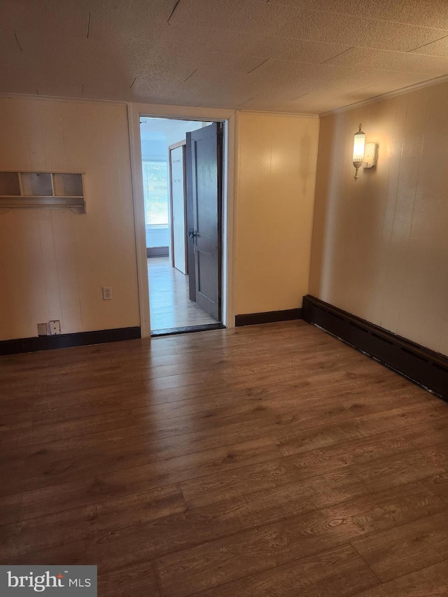 spare room with a textured ceiling and wood-type flooring