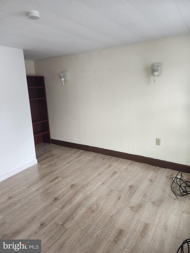 empty room with hardwood / wood-style floors and a textured ceiling