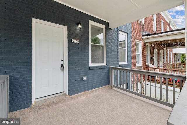 entrance to property featuring a porch