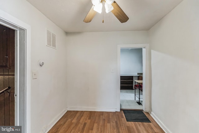 hallway with hardwood / wood-style flooring