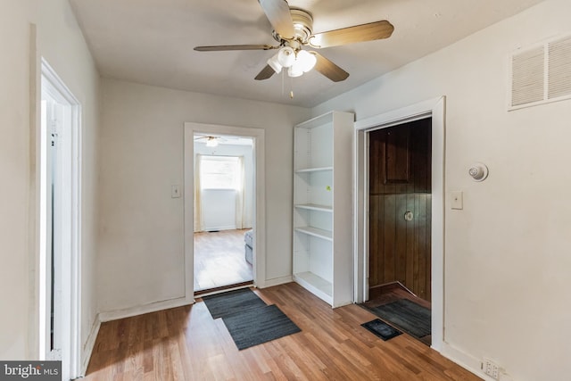 doorway featuring wood-type flooring and ceiling fan