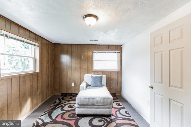 sitting room featuring wooden walls