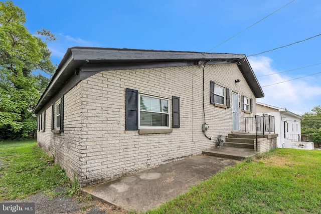 rear view of property with a lawn