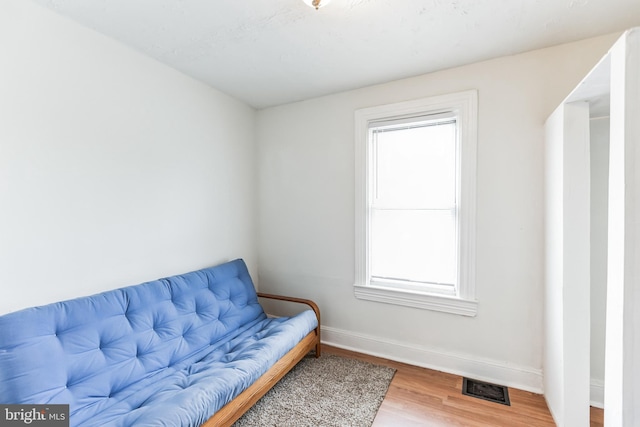 living room with plenty of natural light and hardwood / wood-style floors