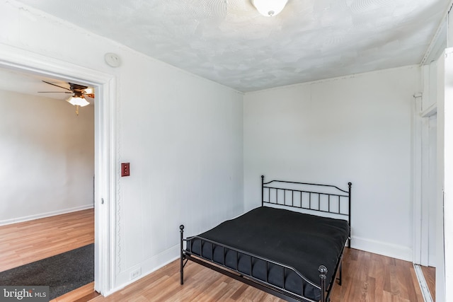 bedroom with hardwood / wood-style flooring and ceiling fan