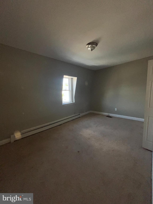 carpeted empty room with a baseboard radiator