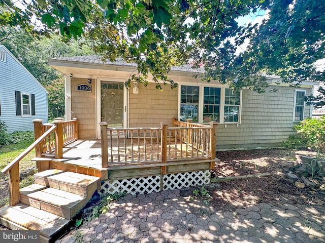 rear view of house featuring a deck