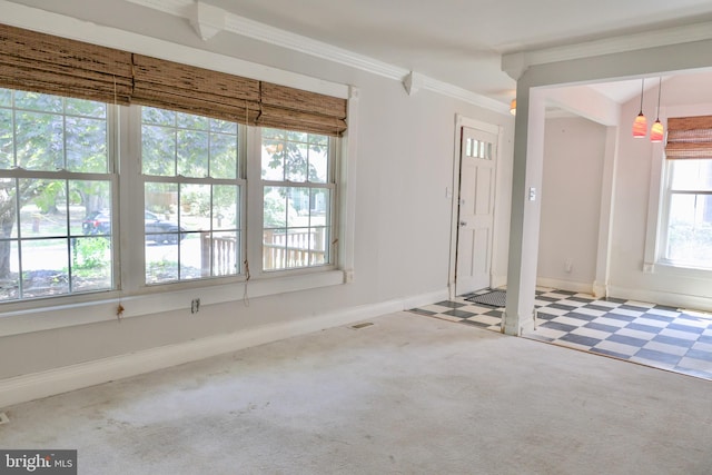 carpeted foyer entrance featuring crown molding