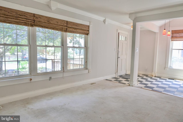 entrance foyer with carpet, crown molding, baseboards, and tile patterned floors