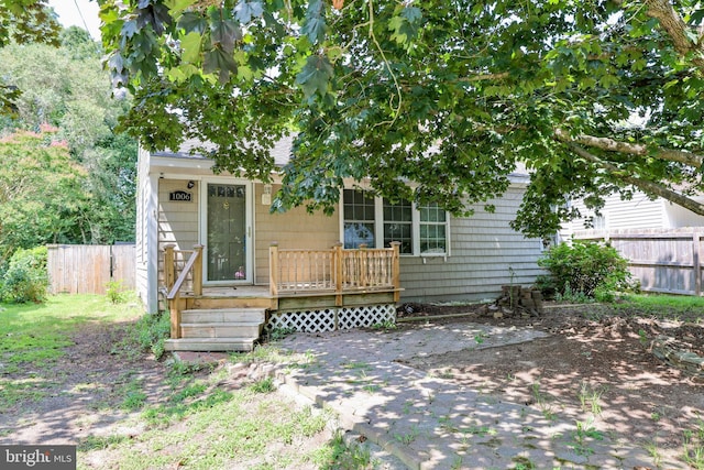 view of front of home featuring fence and a deck