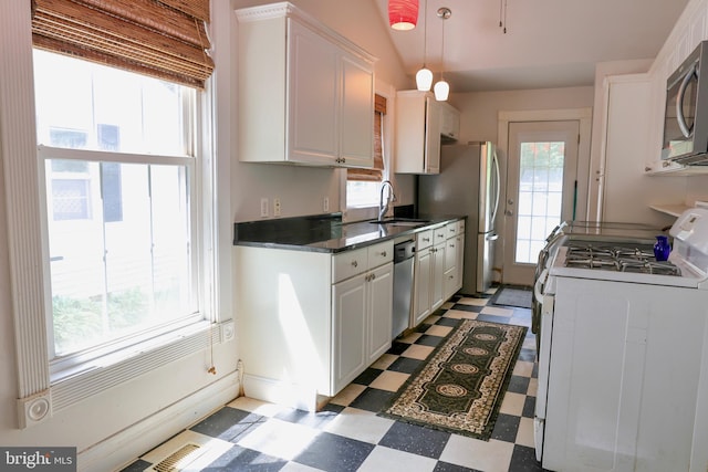 kitchen featuring white cabinets, appliances with stainless steel finishes, and sink