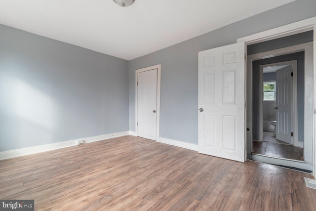 unfurnished bedroom with hardwood / wood-style floors