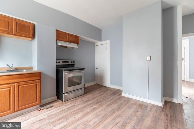 kitchen with electric stove, sink, and light wood-type flooring