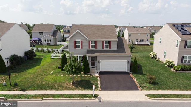 view of property with a front yard and a garage