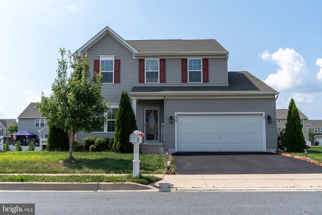 view of front property with a garage and a front yard