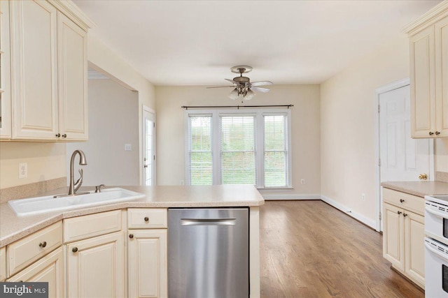 kitchen featuring ceiling fan, cream cabinets, hardwood / wood-style flooring, dishwasher, and sink