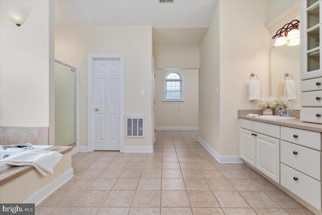 bathroom featuring tile patterned floors, vanity, and independent shower and bath