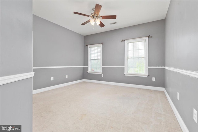 unfurnished room with carpet and ceiling fan