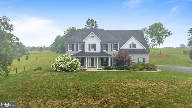 colonial inspired home featuring a front yard