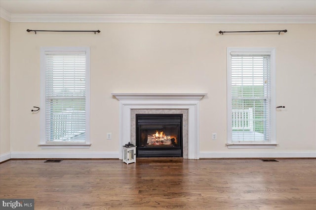 unfurnished living room with a fireplace, hardwood / wood-style floors, and crown molding