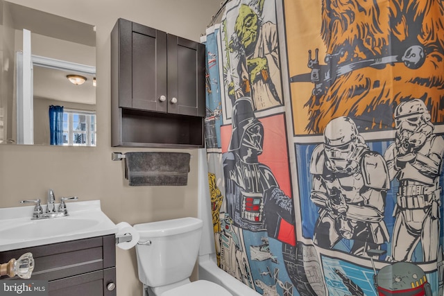 full bathroom featuring vanity, shower / tub combo with curtain, and toilet