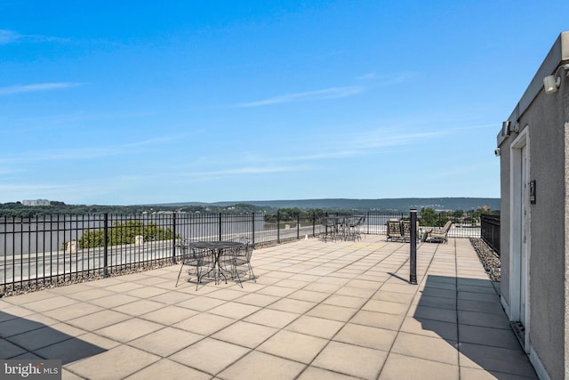 view of patio with a water view