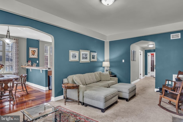 living room with plenty of natural light and wood-type flooring