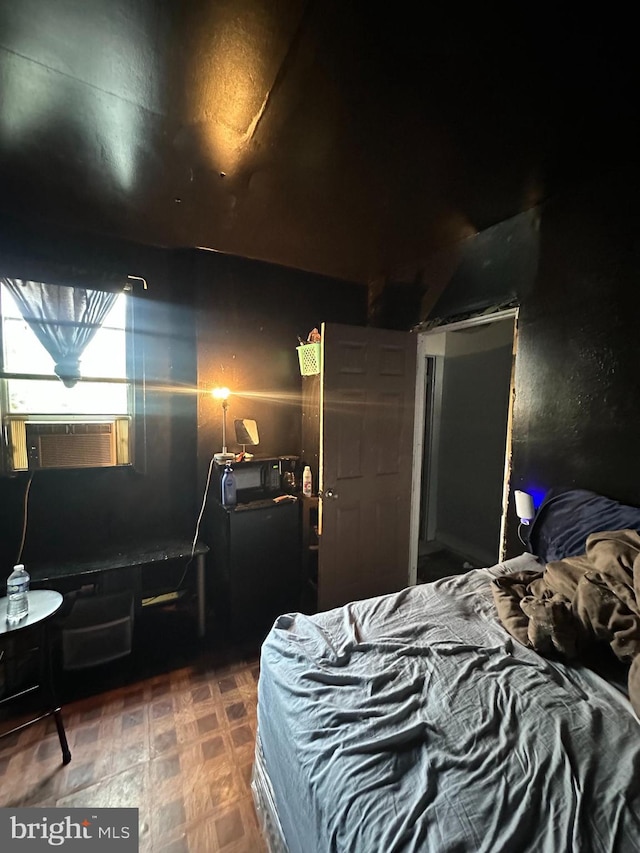 bedroom featuring cooling unit and dark floors