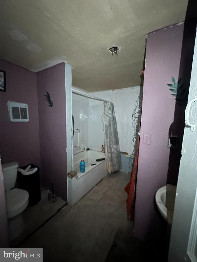 bathroom featuring shower / washtub combination and toilet