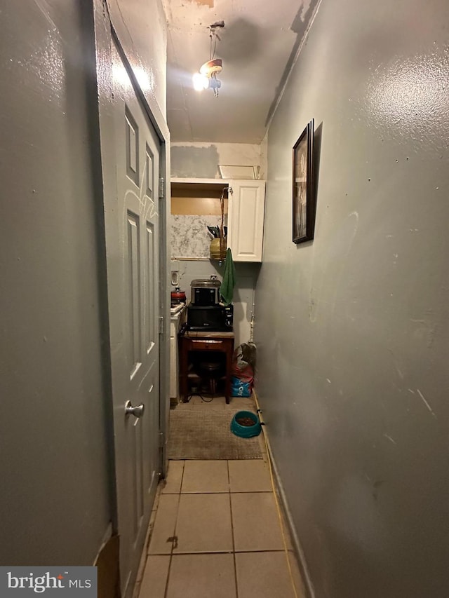 hall featuring light tile patterned floors