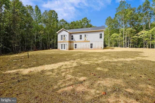 rear view of property with a yard and french doors