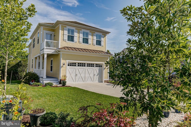 view of front of home featuring a front yard, a balcony, and a garage