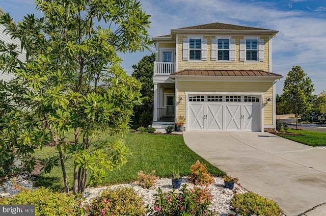 view of front of property featuring a garage and a front yard