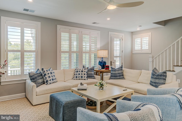 living room featuring light carpet and ceiling fan