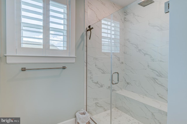 bathroom featuring a shower with shower door