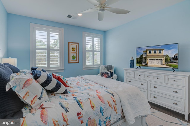 bedroom with ceiling fan and hardwood / wood-style flooring