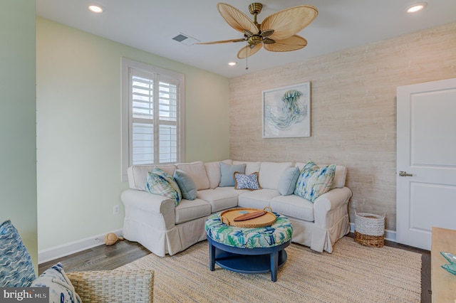 living room featuring ceiling fan and light hardwood / wood-style floors