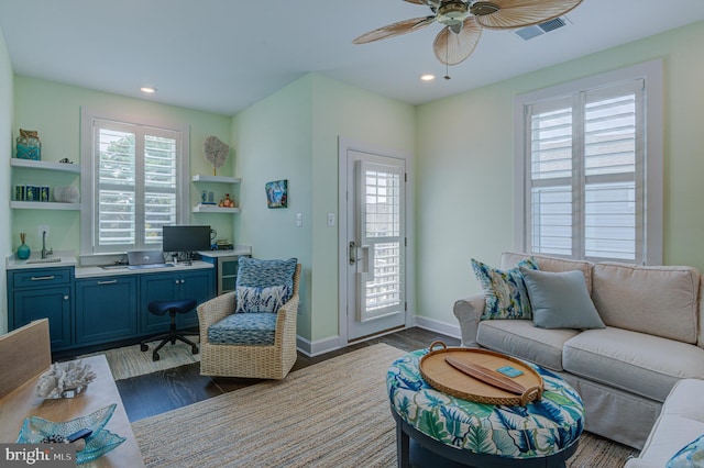 living room with ceiling fan, plenty of natural light, and dark hardwood / wood-style floors