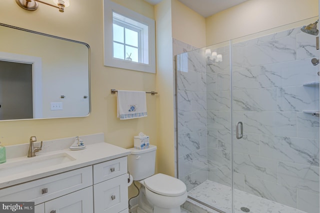 bathroom with vanity, toilet, and an enclosed shower