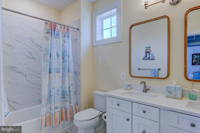 full bathroom featuring vanity, toilet, and shower / bathtub combination with curtain