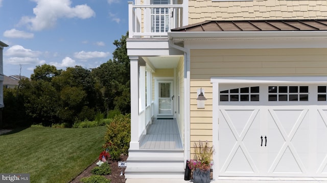 entrance to property with a lawn and a garage