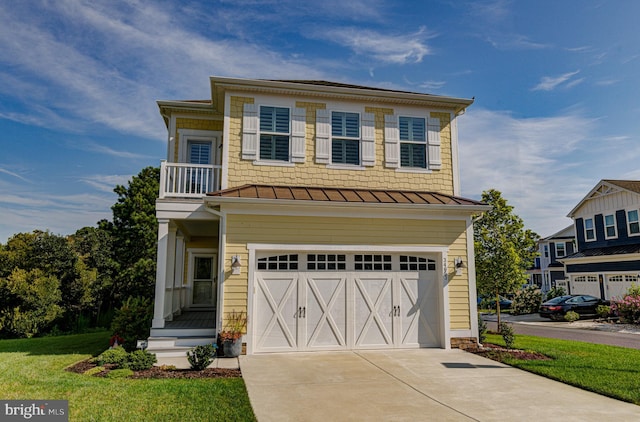 view of front of home featuring a front lawn and a garage