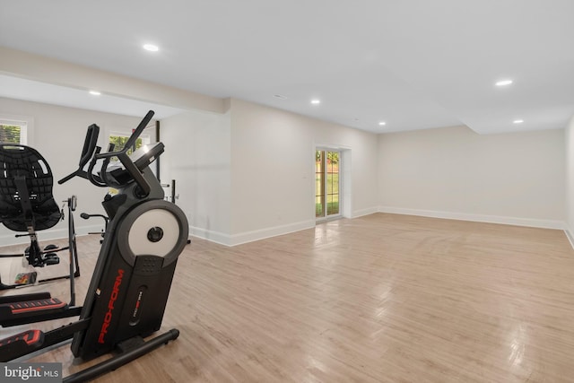 exercise area with light wood-type flooring, baseboards, and recessed lighting