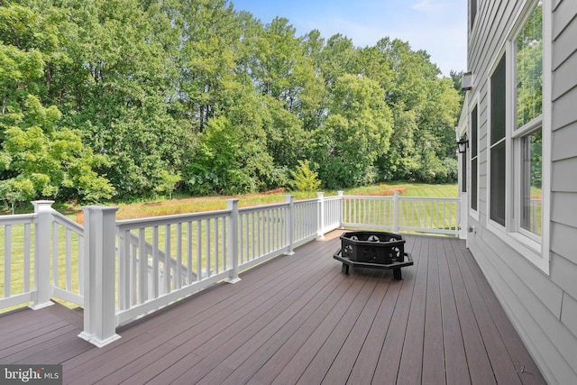 wooden terrace with a fire pit