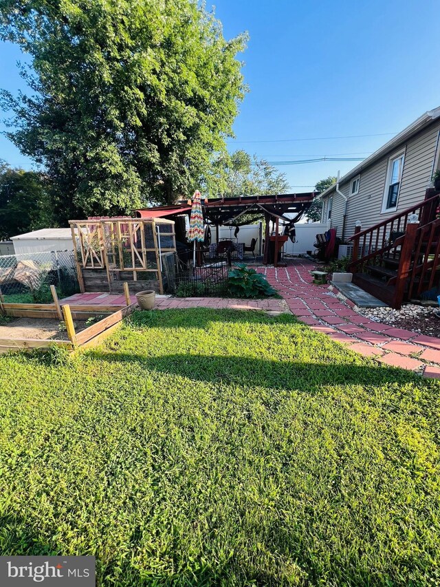 view of yard with a pergola and a patio area