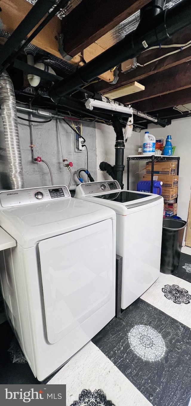 clothes washing area with independent washer and dryer