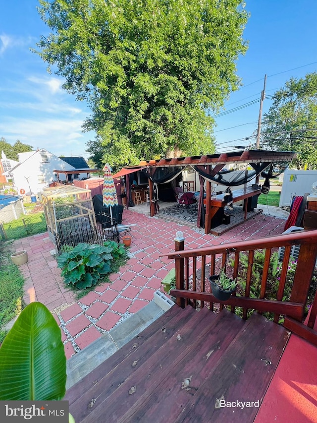 wooden terrace featuring a patio area