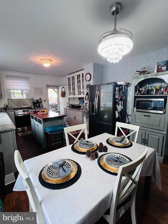 dining area with dark hardwood / wood-style floors and a chandelier