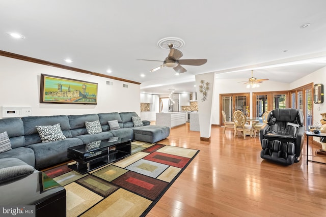 living room featuring light wood-type flooring, ornamental molding, and ceiling fan