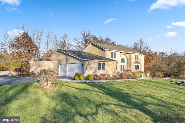 view of front of house featuring a front lawn and a garage